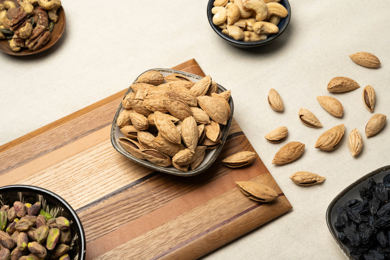Roasted organic almonds in paper bowl