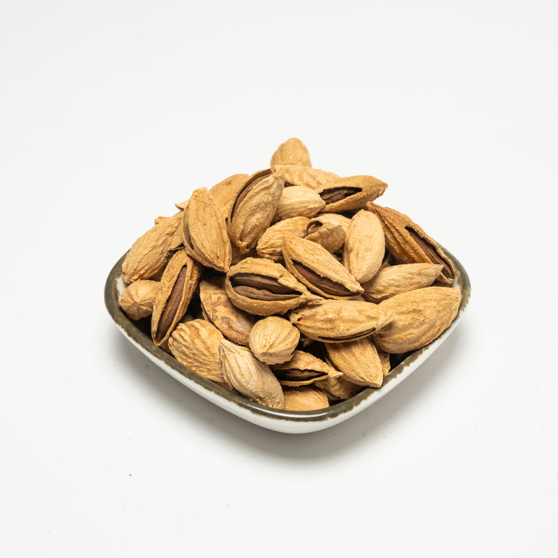Roasted organic almonds in paper bowl
